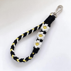 Braid & Carry bold braided cotton phone wristlet in Midnight Daisy with lemon daisy flowers - Rove Cord
