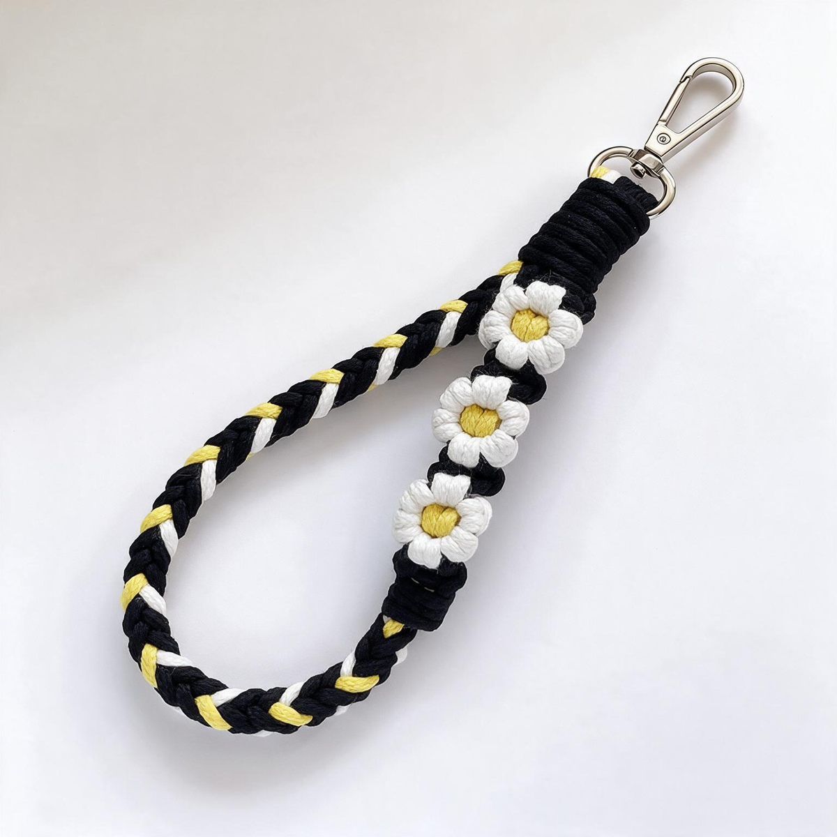 Braid & Carry bold braided cotton phone wristlet in Midnight Daisy with lemon daisy flowers - Rove Cord
